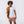 Killer Acid Cretaceous Cosmonauts swim trunks, salmon-orange with teal line-art dinosaurs, aliens and UFOs