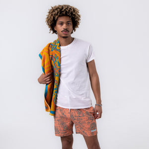 Killer Acid Cretaceous Cosmonauts swim trunks, salmon-orange with teal line-art dinosaurs, aliens and UFOs