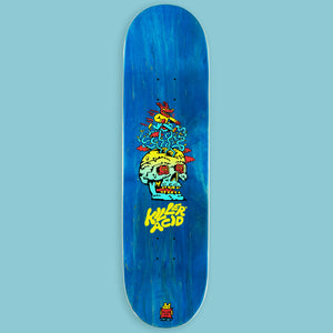 Blue 8.25" maple skateboard deck with "Pay No Mind" Killer Acid skull graphic.