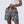 Killer Acid Summer Slime swim trunks with a busy cartoon print of melting slime, smiley suns and skulls in teal, orange and yellow