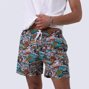 Killer Acid Summer Slime swim trunks with a busy cartoon print of melting slime, smiley suns and skulls in teal, orange and yellow