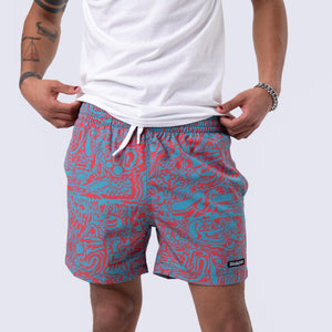 Killer Acid Wild Shroom swim trunks with an all-over teal and coral print of wild melting creatures and critter faces
